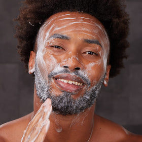 Hands holding Bulldog face scrub displaying texture for gentle exfoliation