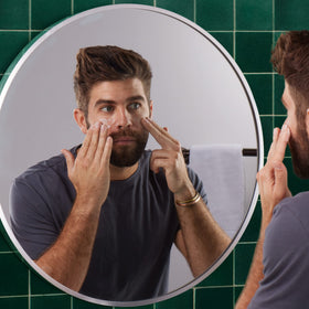 Applying Bulldog moisturizer to jawline demonstrating fast absorption benefit