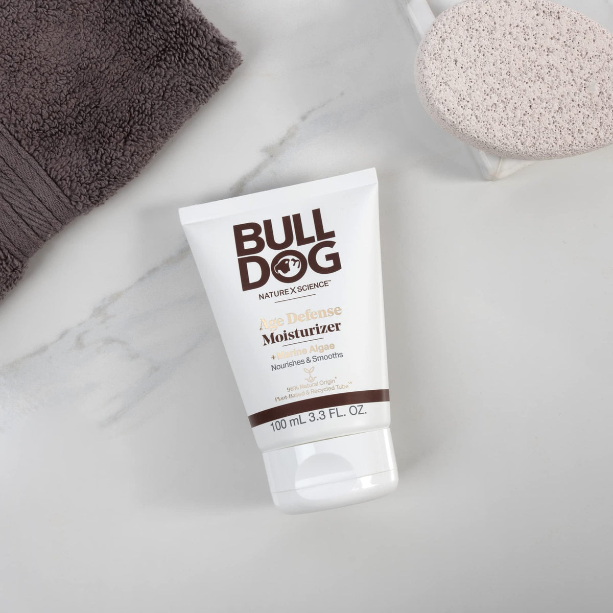 Bulldog tube next to ruler showing 3.3 fl oz size and travel-friendly convenience