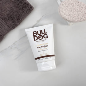 Bulldog tube next to ruler showing 3.3 fl oz size and travel-friendly convenience