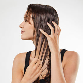 Bumble and bumble cream on hand before applying to damp hair for protection