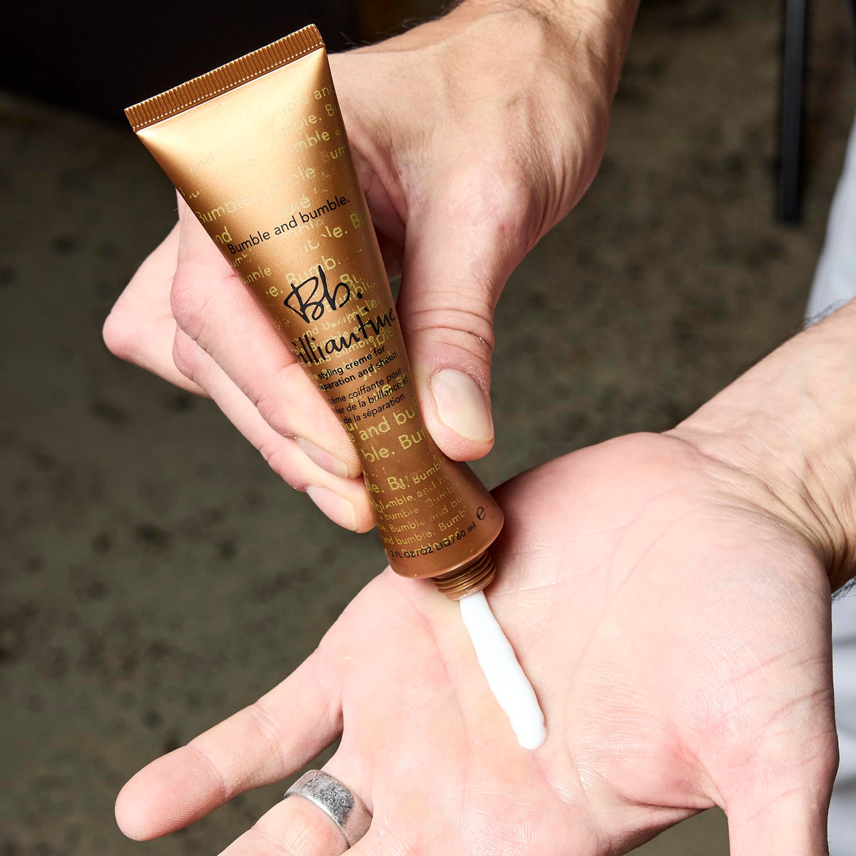 Bumble and bumble styling cream on hands demonstrating easy application and controlled amount