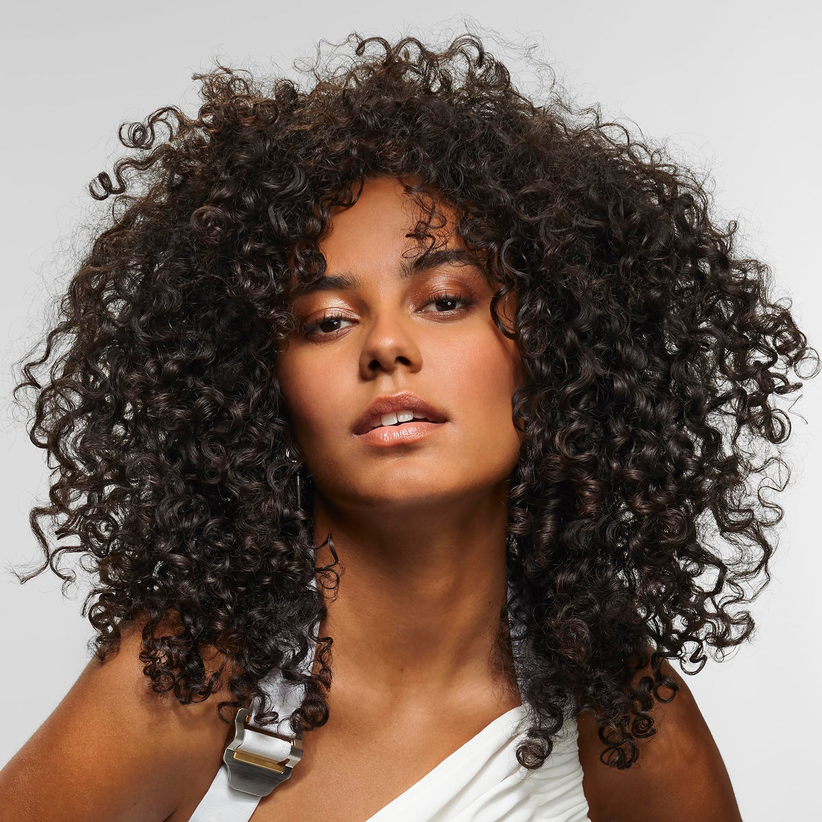 bumble and bumble styled curly hair after use showing reduced frizz and shine