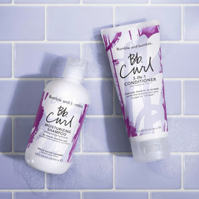 Bumble and bumble. damp curly hair after rinse showing enhanced softness and definition