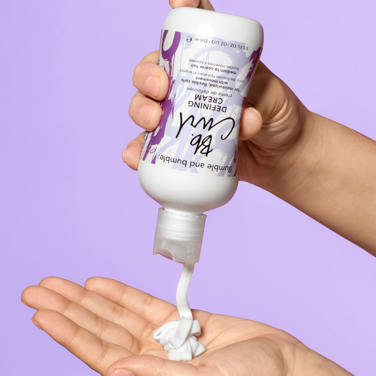 Bumble and bumble being applied to damp curls to define and reduce frizz