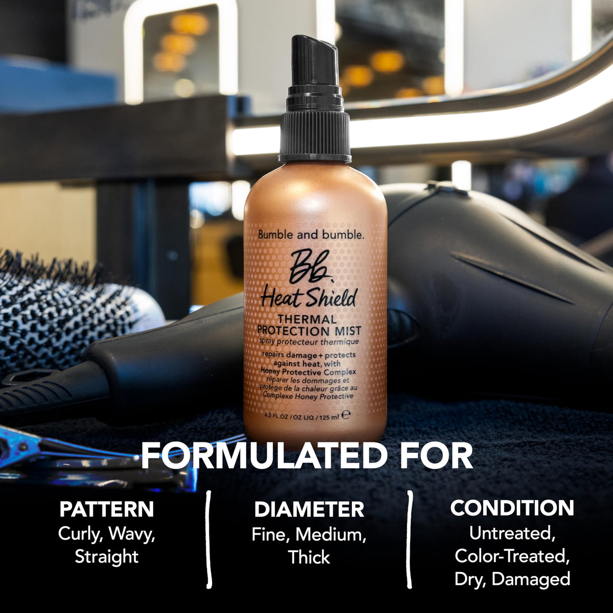Bumble and bumble being sprayed on dry hair to protect against heat tools