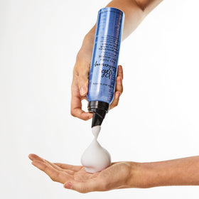 Bumble and bumble can in hand demonstrating 5 ounce scale for travel-friendly benefit