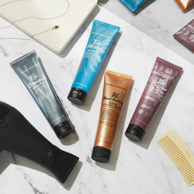 Bumble and bumble styled sleek hair in lifestyle shot showing frizz reduction benefit