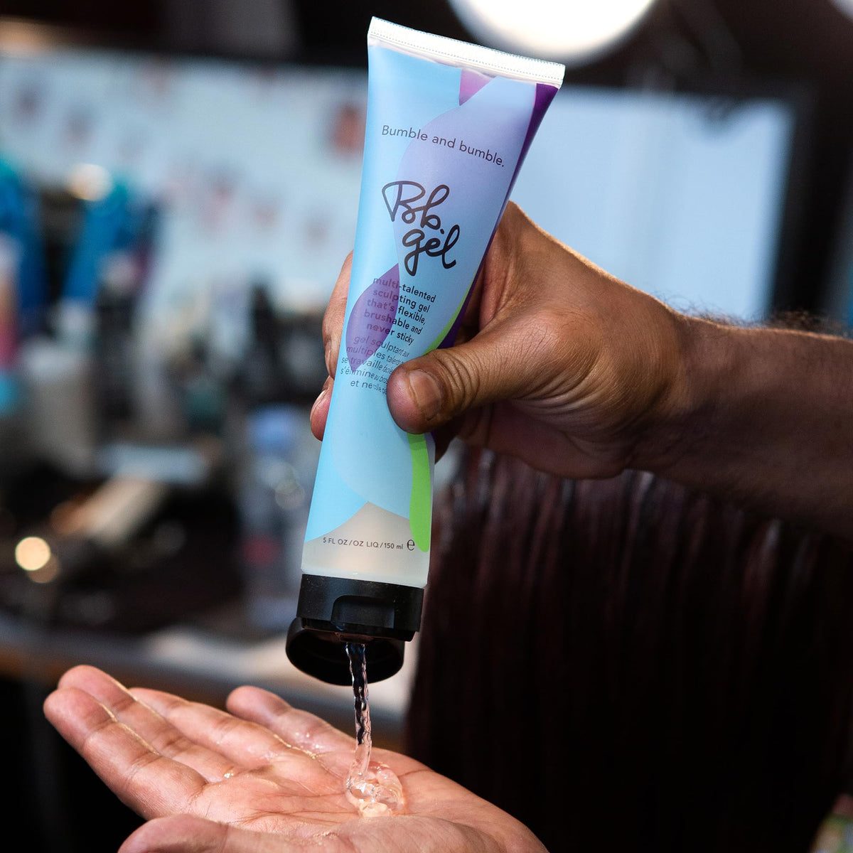 Bumble and bumble styling in use shaping hair for defined, brushable hold