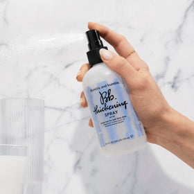 Bumble and bumble mist on hair strands creating instant texture and fullness