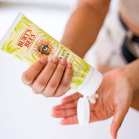 Burt's Bees open cap and lotion texture highlighting quick absorption