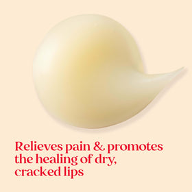 Burt's Bees balm spread on fingertip, hydrating oils visibly nourishing lips