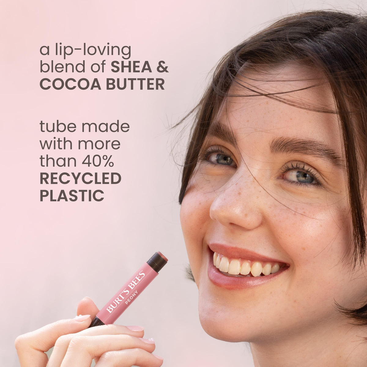 Burt's Bees stick held in hand showing travel-friendly size and portability