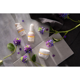 Lifestyle shot of Burt's Bees cream among botanicals conveying cruelty-free natural care