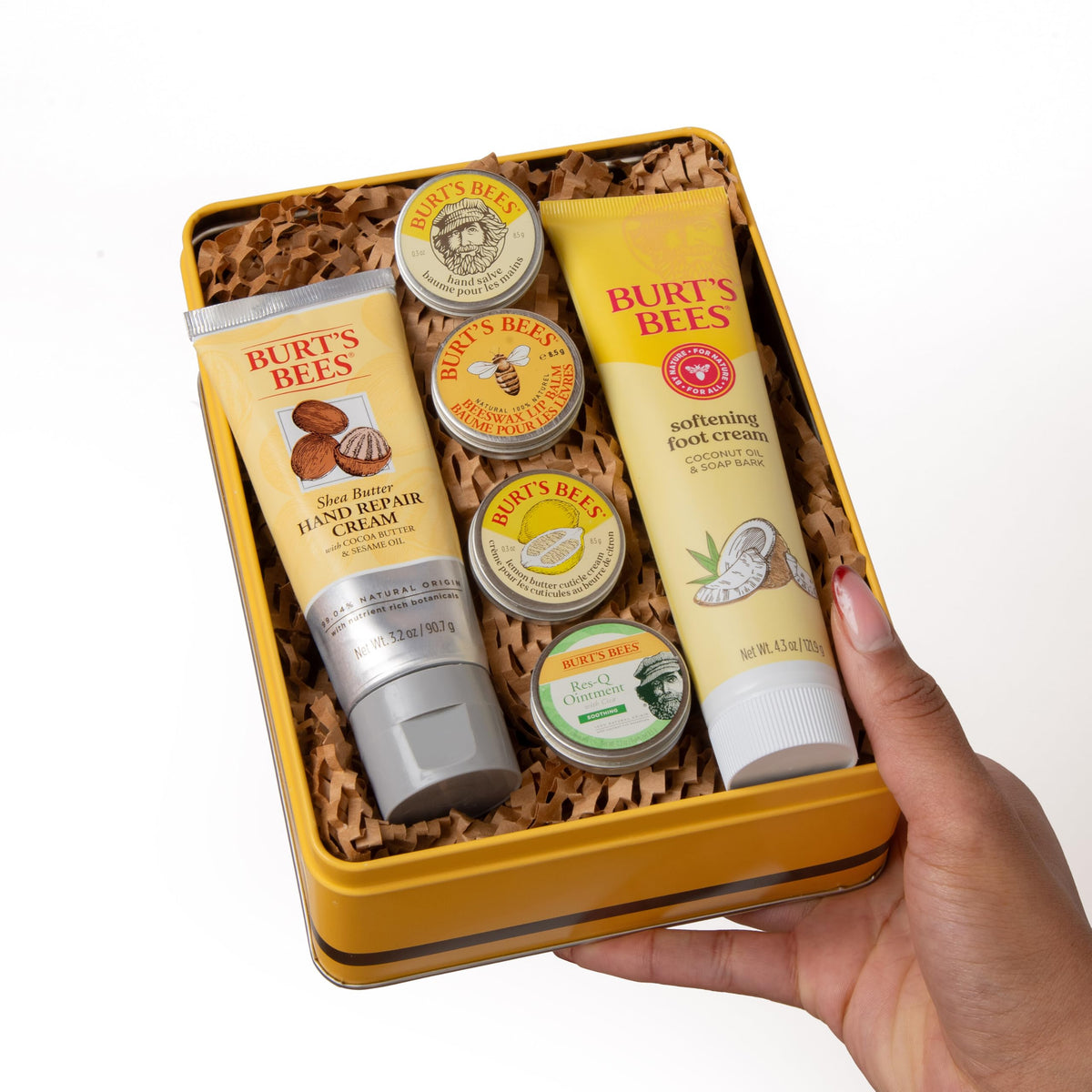 Burt's Bees Coconut Foot Cream tube beside foot to show rich hydrating relief