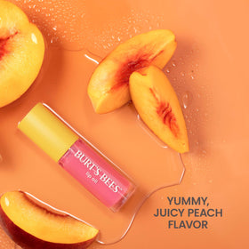 Burt's Bees Peach flavor cue near the lip oil, indicating delicious scent