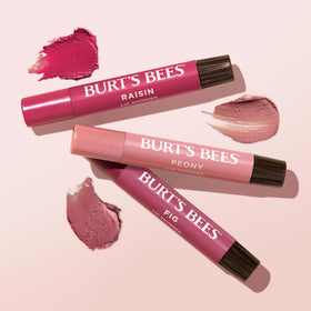 Burt's Bees trio in a handbag showing everyday travel-ready use