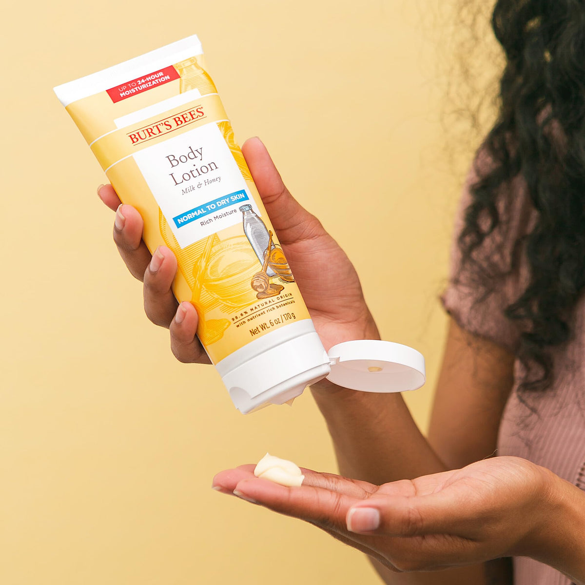 Burt's Bees lotion texture on hand, demonstrating quick absorption benefit