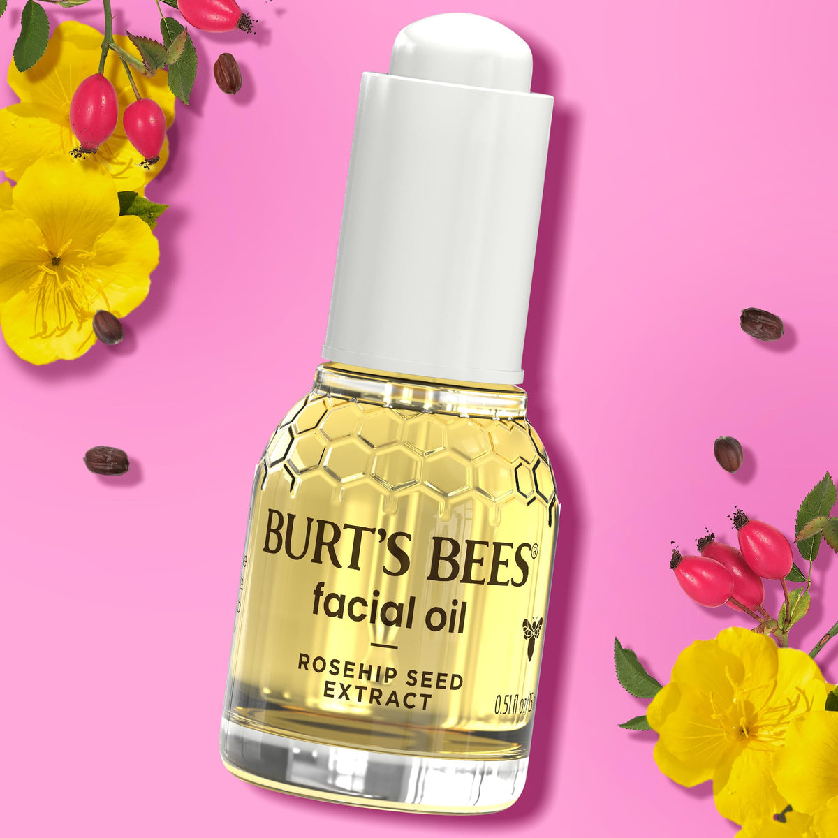 Burt's Bees bottle next to coin for scale, highlighting travel-friendly 0.51 fl oz size