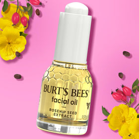 Burt's Bees bottle next to coin for scale, highlighting travel-friendly 0.51 fl oz size