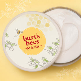 Burt's Bees spoon scooping cream demonstrating thick balm consistency and spreadability