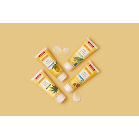 Burt's Bees creamy lotion texture on spoon, demonstrates rich fast-absorbing feel