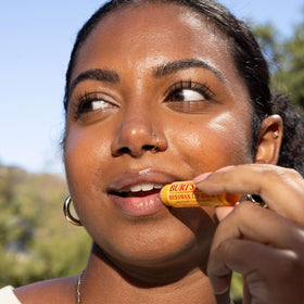 Burt's Bees texture swiped on fingers demonstrating smooth glide