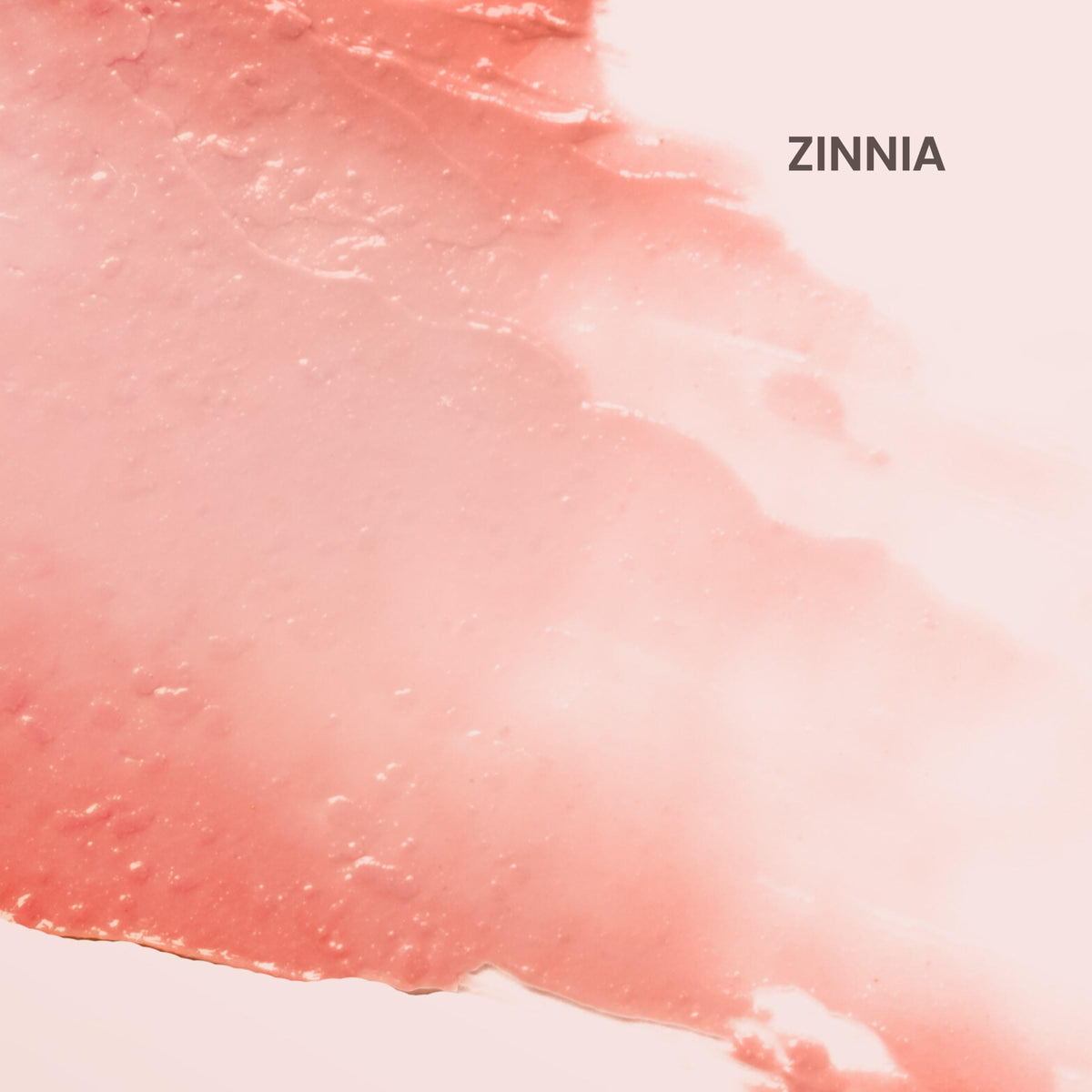 Burt's Bees swatch of Zinnia on hand showing sheer coral color and natural finish benefit