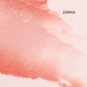 Burt's Bees swatch of Zinnia on hand showing sheer coral color and natural finish benefit