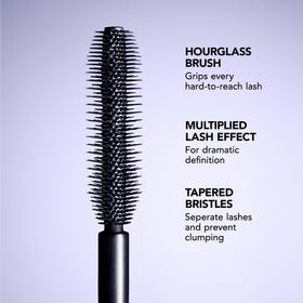 Buxom mascara next to a coin for size comparison and travel-friendly scale