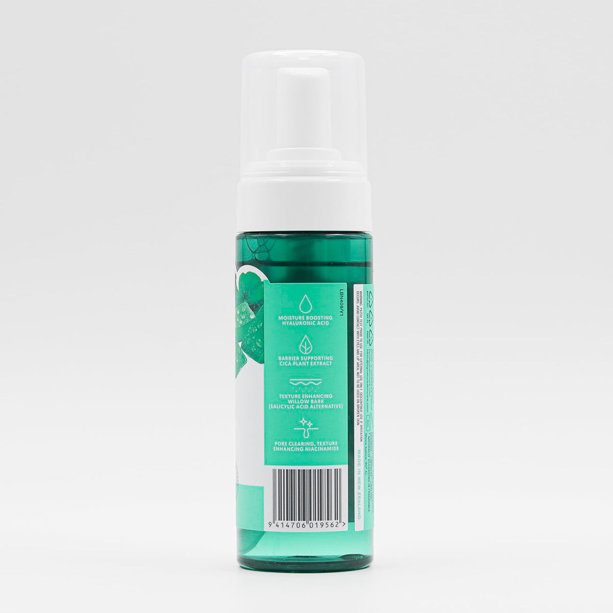 By Nature cleanser staged on bathroom shelf with towel, suggests daily routine use