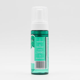 By Nature cleanser staged on bathroom shelf with towel, suggests daily routine use