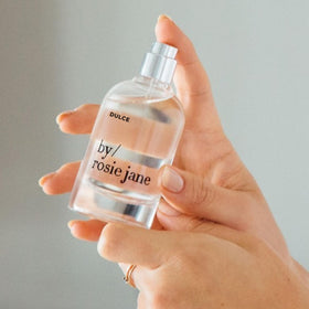 By Rosie Jane bottle held in hand to show 50ml scale and travel-friendly benefit