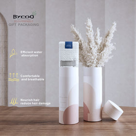 BYCOO towel on bathroom shelf with spa items suggesting gentle, family-friendly drying