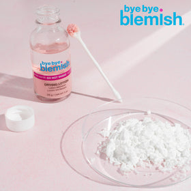 Bye Bye Blemish bottle on nightstand beside skincare items showing bedtime routine benefit overnight action