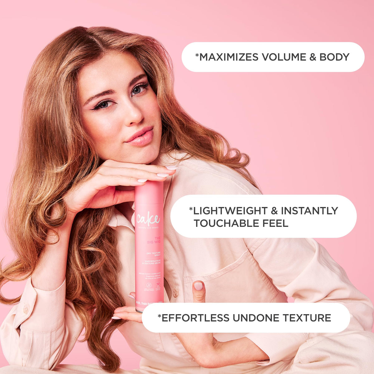 Cake Beauty spraying texture spray into dry hair to add lift and natural-looking volume