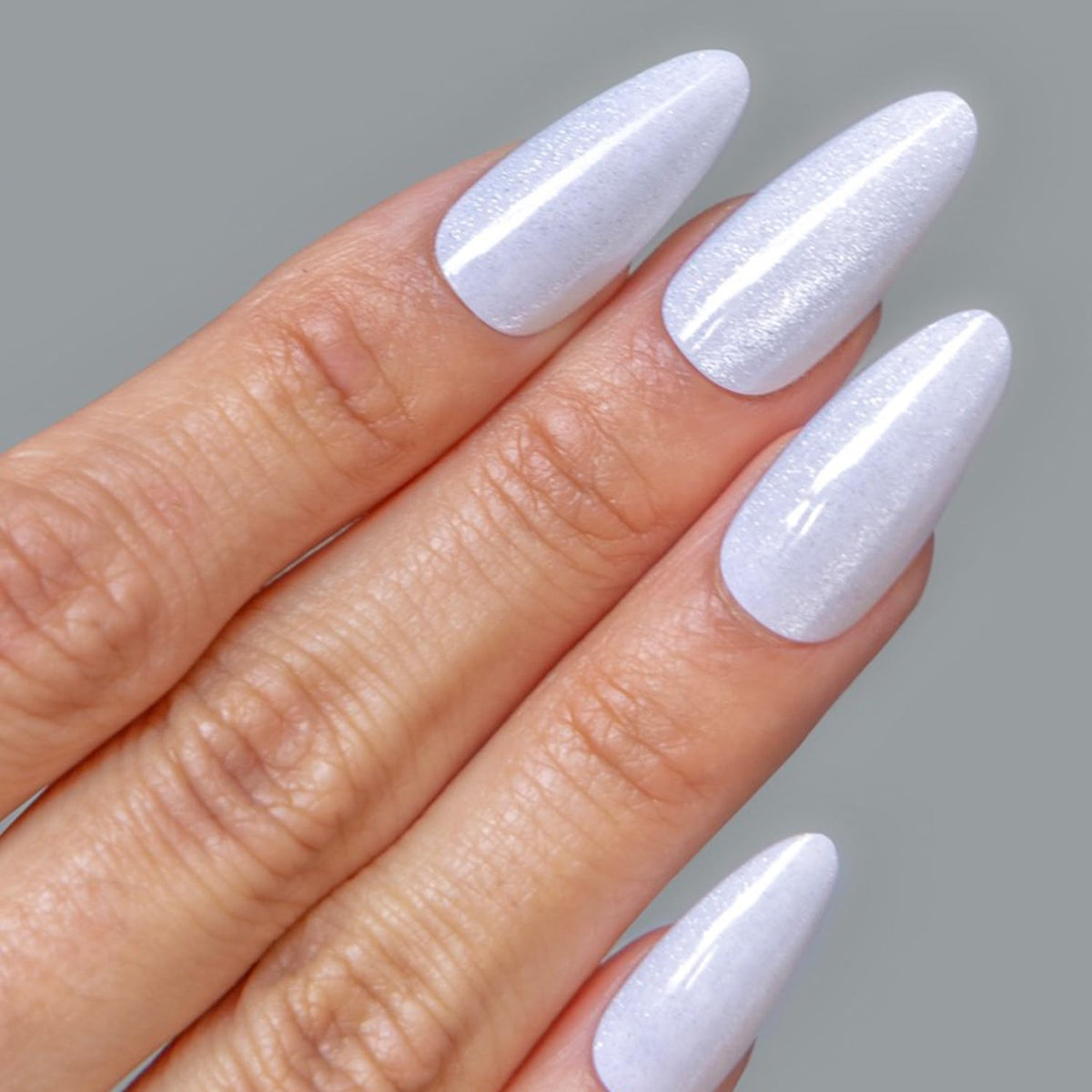 CALA applying glue to a false nail illustrating quick secure attachment benefit