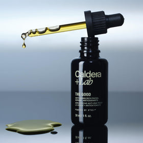 Caldera + Lab hand applying serum demonstrating easy spreadability and non-greasy finish