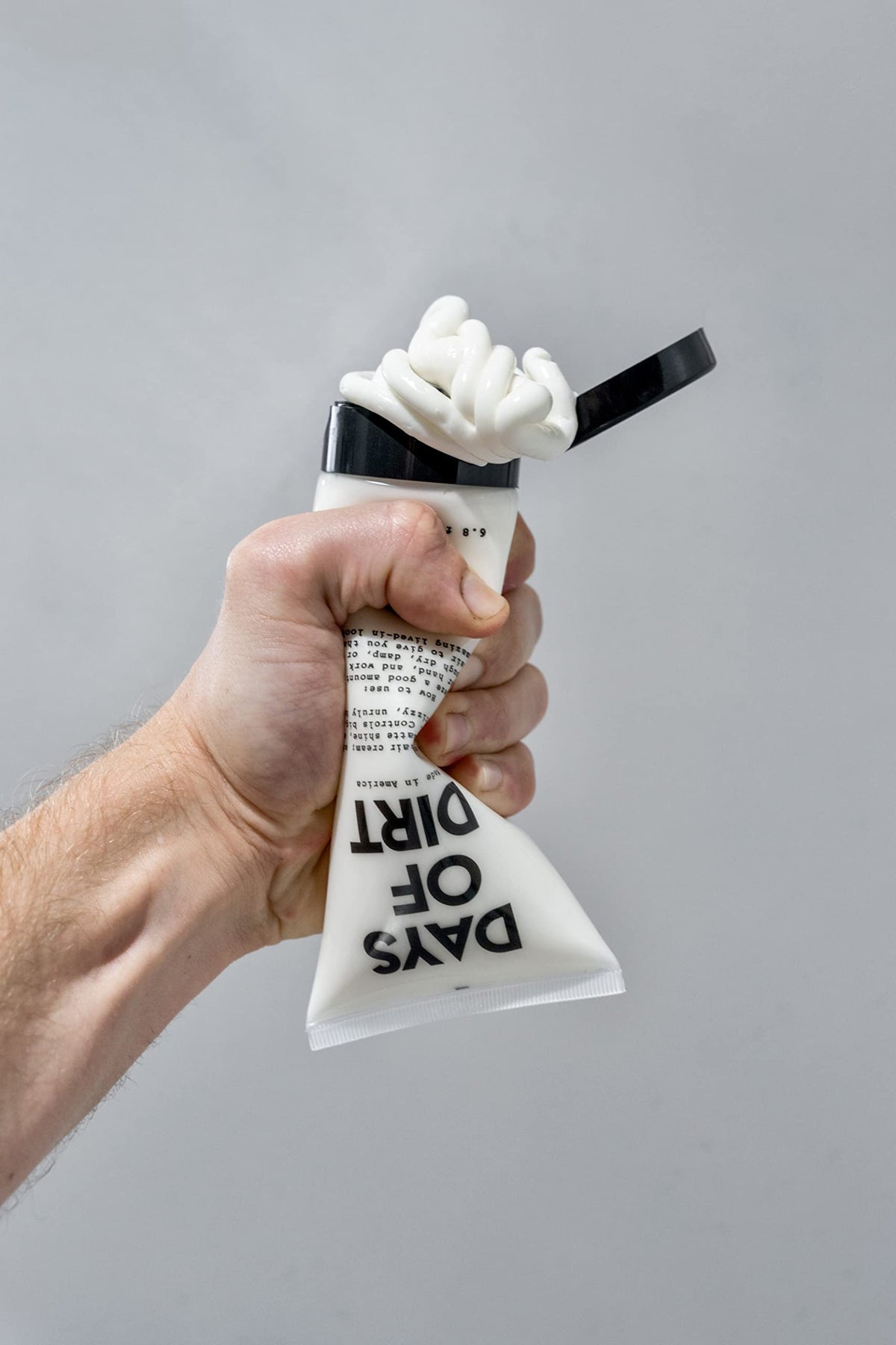 California Born tube on bathroom shelf with styling tools showing daily convenience