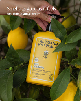 California Naturals bottle in hand conveying 16.5 oz scale and travel-friendly use