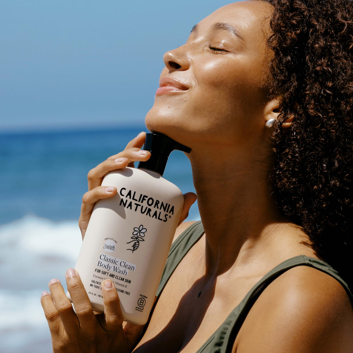 California Naturals two 20 oz bottles next to a hand to show scale and convenience
