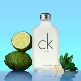 Calvin Klein CK One next to everyday items showing 3.3 fl oz size and portability