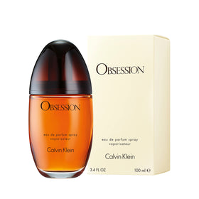 Calvin Klein Obsession bottle on evening table setting, suggests warm, sensual wear for nights