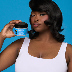 Camille Rose being applied to wet hair from hand demonstrating even coverage and manageability