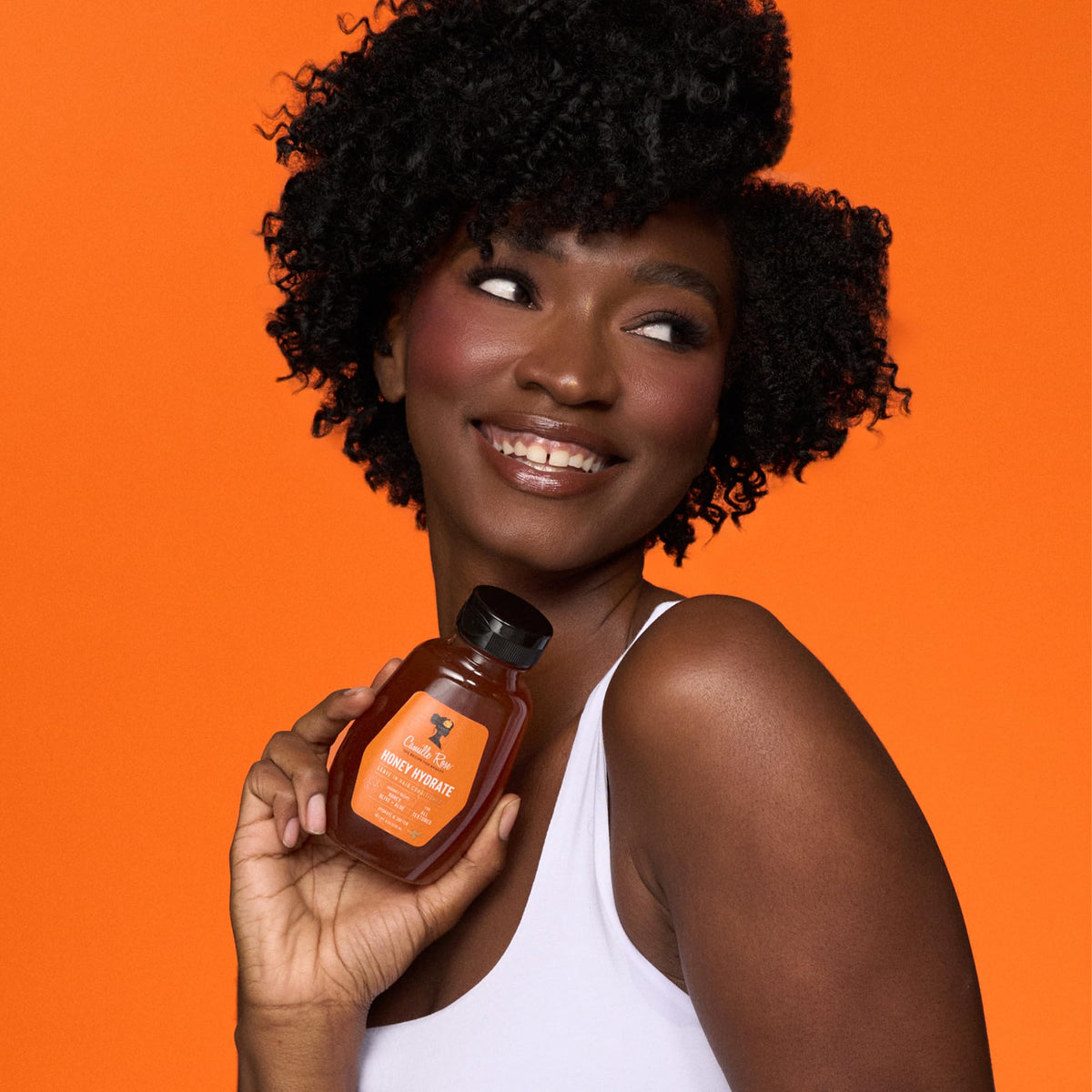 Camille Rose being applied to braided hair to detangle and reduce frizz