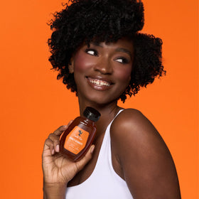 Camille Rose being applied to braided hair to detangle and reduce frizz