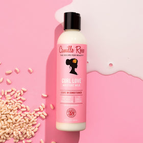 Camille Rose milky leave-in texture on hand, showing lightweight hydration and smooth spreadability