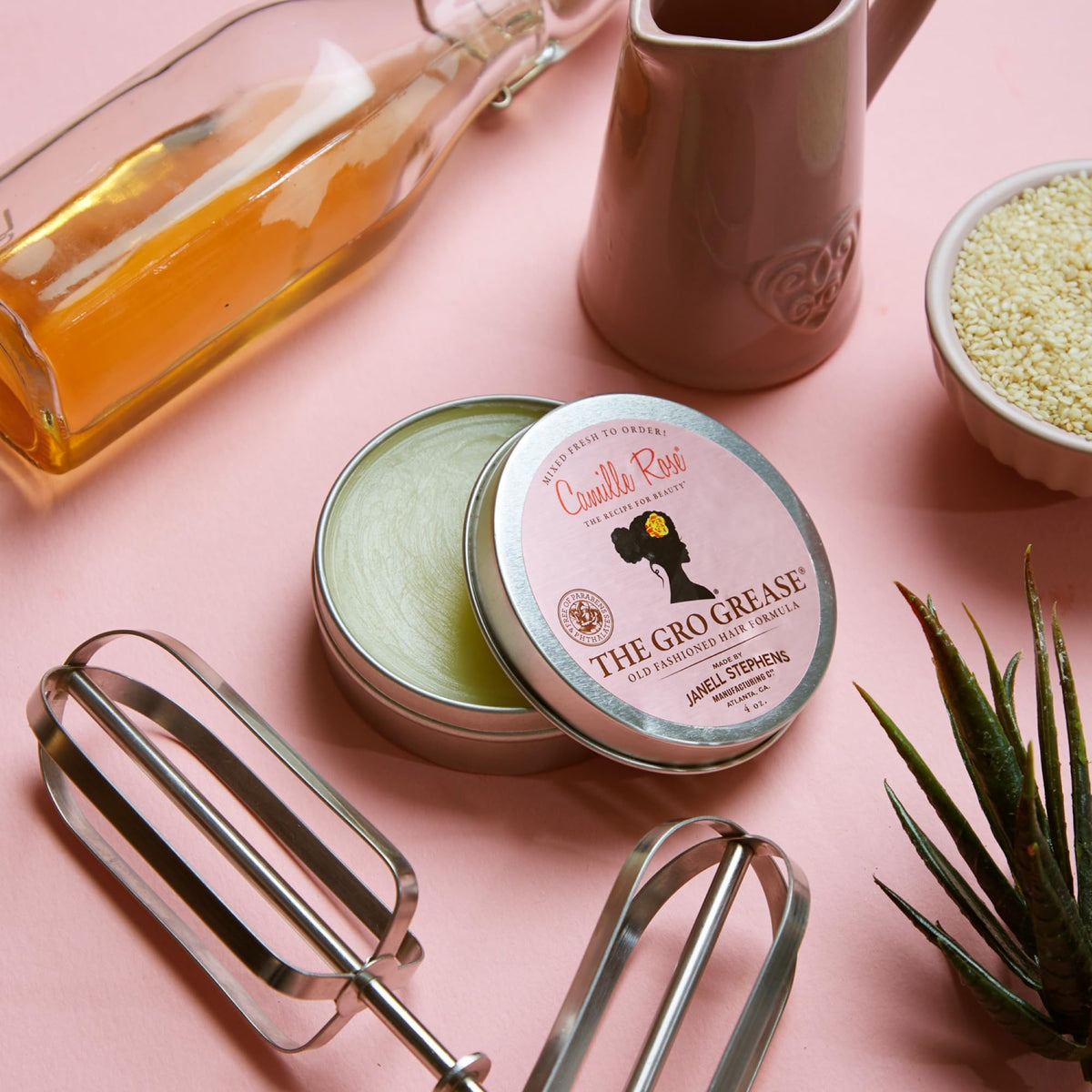 Application of Camille Rose grease to scalp demonstrating soothing hydration