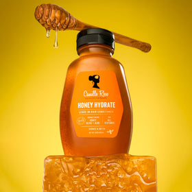 Application of Camille Rose leave-in on damp hair demonstrating detangling and slip benefit