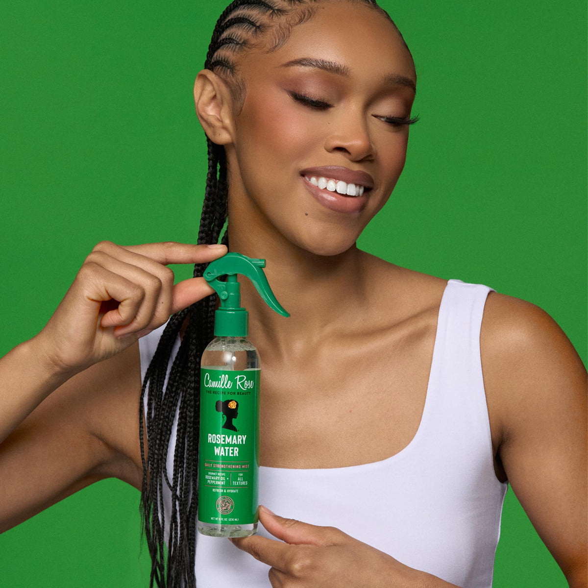 Camille Rose in-use refreshing hair spray on curls, revives and defines